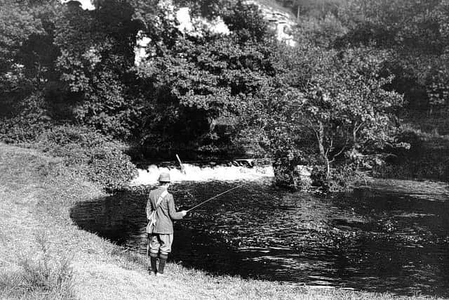 circa 1915:  A man fishing in the River Derwent in the Forge Valley near Scarborough.  (Photo by Hulton Archive/Getty Images)