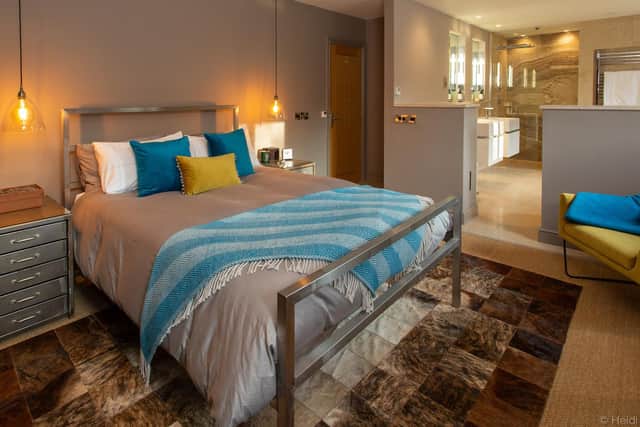 The enormous main bedroom suite with rugs to soften the tiles, new lighting and colour to add warmth and interest