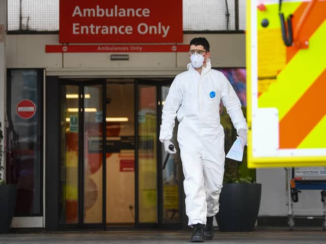 A paramedic wearing personal protective equipment (PPE) outside a hospital as concerns grow about the testing of NHS staff and patients for Covid-19.