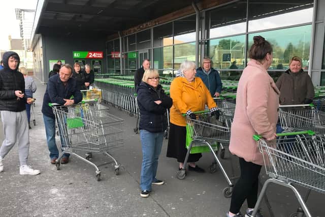 Queues outside Asda prior to new measures being imposed.
