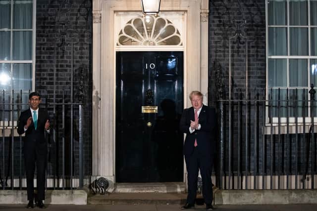 Prime Minister Boris Johnson (right) and Chancellor Rishi Sunak outside 10 Downing Street, London, joining in with a national applause for the NHS to show appreciation for all NHS workers who are helping to fight coronavirus.