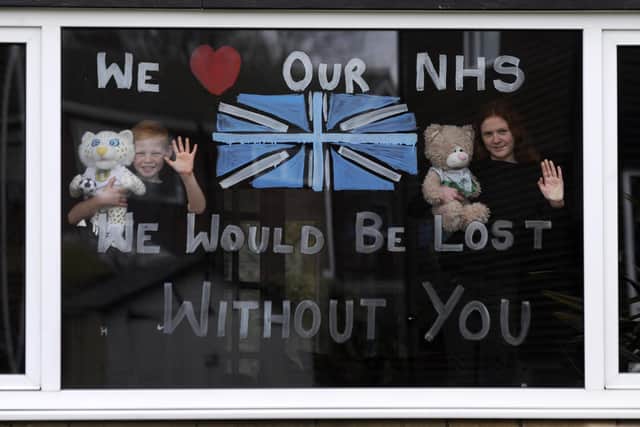 Lydia Hardwick aged 11 with her brother Daniel aged 8, support the NHS by painting their window through the coronavirus outbreak at Oulton, Leeds.