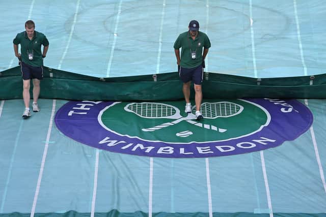 Ground staff take the covers off Centre Court. PA Photo. Issue date: Wednesday April 1, 2020. Wimbledon 2020 has been cancelled due to the coronavirus pandemic, the All England Lawn Tennis and Croquet Club has announced.  (Picture: Philip Toscano/PA Wire)