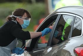 A person is tested at a drive through coronavirus testing site in a car park at Chessington World of Adventures, in Greater London, as the UK continues in lockdown to help curb the spread of the coronavirus. Photo: PA