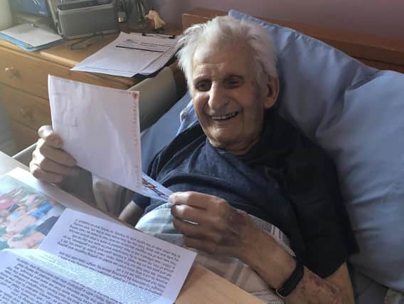Fulford care home resident, Wally, reading one of the letters sent to him by members of the public.