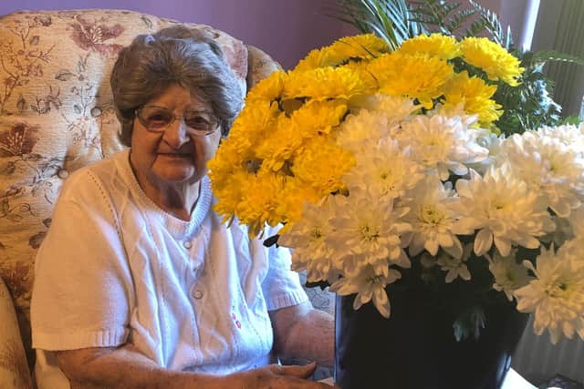 Resident Ethel with some flowers sent by well-wishers.