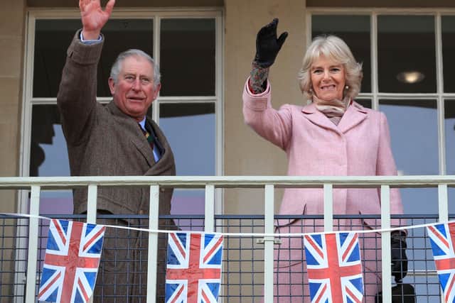 The Prince of Wales and The Duchess of Cornwall wave to the crowd during a visit to the Piece Hall. Picture: Peter Bryne/PA Wire