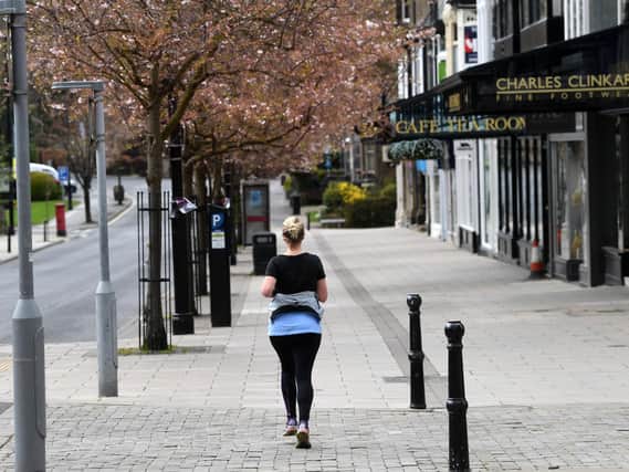 A woman jogs through a deserted Ilkley on Saturday