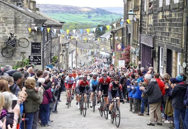 Riders in the 2019 Tour de Yorkshire climb a hill in Haworth, during stage four of the Tour de Yorkshire. Picture: Martin Rickett/PA Wire.