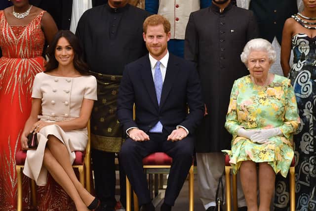 Meghan, Duchess of Sussex, Prince Harry, Duke of Sussex and Queen Elizabeth II at the Queen's Young Leaders Awards Ceremony at Buckingham Palace on June 26, 2018 in London, England. (Photo by John Stillwell - WPA Pool/Getty Images)
