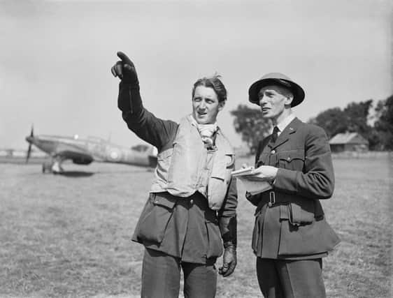 Flying Officer Anthony Eyre DFC of B Flight No.615 (County of Surrey) Squadron Royal Auxiliary Air Force debriefs with his squadrons Intelligence Officer (right) having just shot down two enemy aircraft on 15th August 1940 during the Battle of Britain at RAF Hawkinge near Folkestone, Kent, England.  (Photo by Central Press/Hulton Archive/Getty Images)