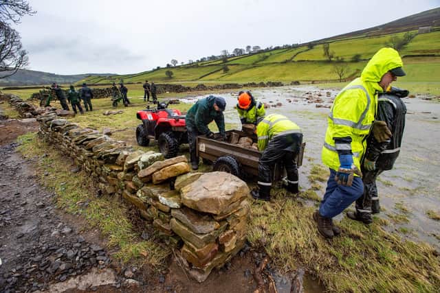 Volunteers helping the Yorkshire Dales National Park Authority repair flood damage in Swaledale in February.


Picture: Bruce Rollinson