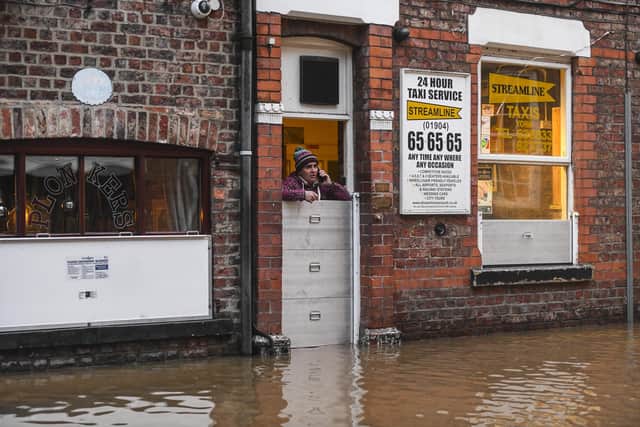 A man looks out at the flood waters approaching his business on the banks of the River Ouse in York, North Yorkshire - 18th February 2020, in the aftermath of Storm Dennis. Picture: SWNS
