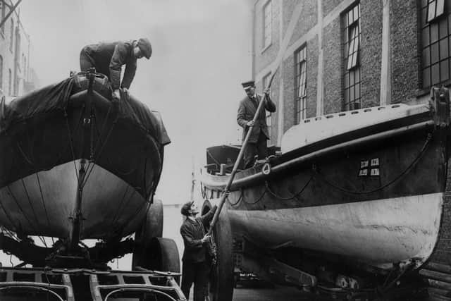 13th February 1924:  Two lifeboats arrive for repairs at the depot of the Royal National Lifeboat Institution in Poplar, London on the centenary of the organisation. Over 59,000 lives have been saved over the years by the RNLI, a charity-funded service.  (Photo by A. R. Coster/Topical Press Agency/Getty Images)