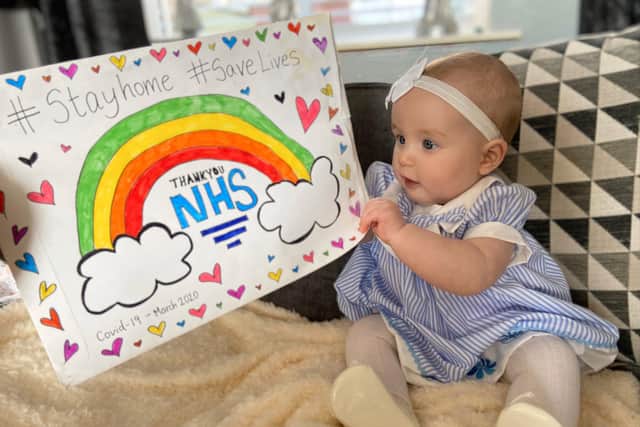 This toddler shows her supprot for the NHS after medical treatment.