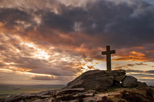 The Rylstone Cross at sunset, perched on the crags. Picture: Bruce Rollinson.