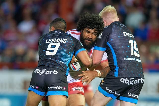 Huddersfield's Kruise Leeming and Oliver Wilson hold Mose Masoe of Hull KR (Picture: Bruce Rollinson)