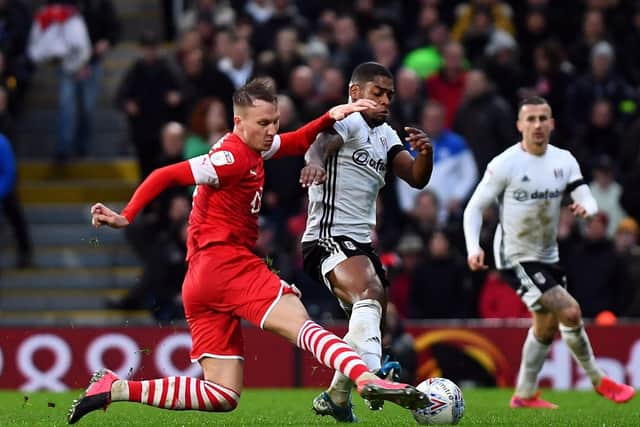 IN THE THICK OF IT: Barnsley's Cauley Woodrow battle for the ball with Fulham's Ivan Cavaleiro. Picture: Victoria Jones/PA