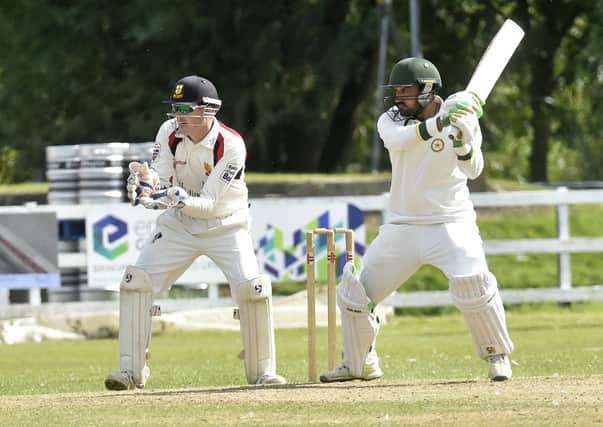 ON HOLD: Wrenthorpe's 
Khalil Khan cuts through square for on his way to 55 against Bradford and Bingley, to ensure his team stayed up in Bradford League Premier Division on the last day of the 2019 season. Picture: Steve Riding.