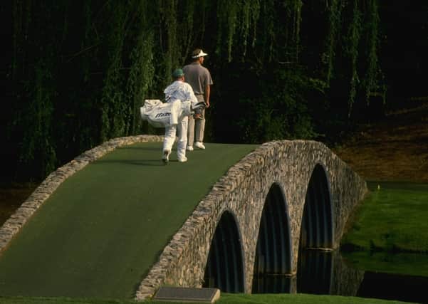 Sandy Lyle and his caddie walk across Hogan's Bridge during the 1988 Masters at the Augusta National Golf Club (Picturet: Allsport UK /Allsport)