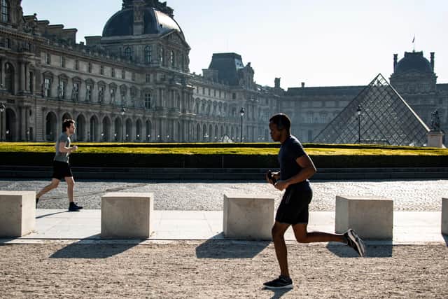 A jogger runs near the Louvre in Paris where support for the Queen continues to grow.