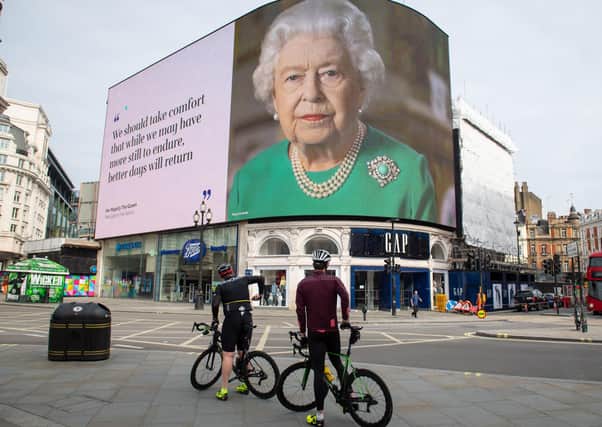 An image of Queen Elizabeth II and quotes from her broadcast  to the UK and the Commonwealth in relation to the coronavirus epidemic are displayed on lights in London's Piccadilly Circus.