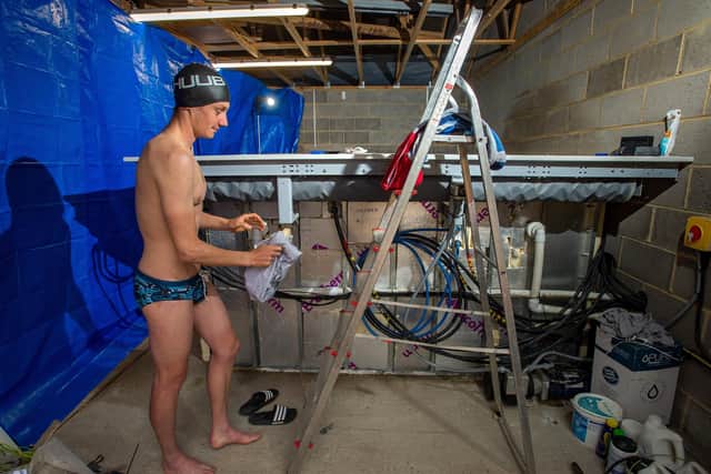 Alistair Brownlee prepares for a triathlon training session - by swimming in his garage.