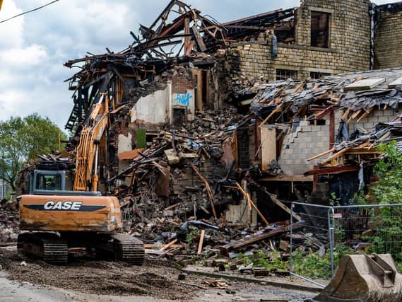 The start of the demolition work at the old Walkleys Clogs Mill, on Burnley Road, Mytholmroyd, after a fire ripped through the build in August 2019. 
Picture James Hardisty.