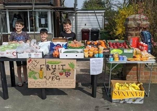 Angela Barry's three sons, (left to right) Ben Barry, 7, Isaac Barry, 4, and Joshua Barry, 9, with their fruit and veg stall. Angela Barry, a church administrator from Breightmet, in Bolton, Greater Manchester, has, with the help of her 3 sons have been helping more than 50 isolated neighbours needing food or a friend during lockdown. Photo: Angela Barry/PA Wire