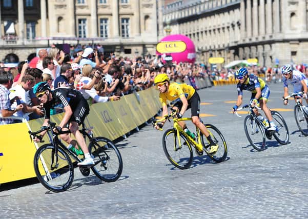 Great Britain's Bradley Wiggins of Sky Pro Racing (yellow jersey), follows team mate, Chris Froome (left), in the Tour de France.