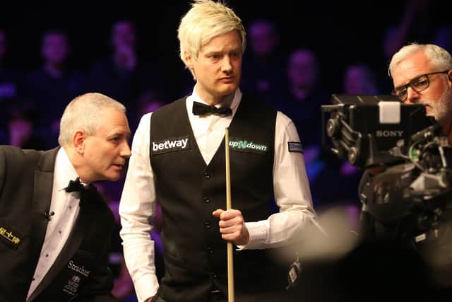 In position: Neil Robertson and referee Brendan Moore look at the TV monitor to check ball placement at the UK Championship last year.
