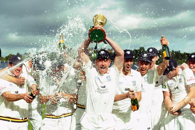 Champions: Durham captain Paul Collingwood celebrates their County Championship title success in 2013.
