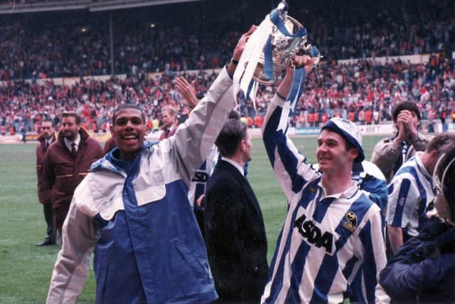 HIGH TIMES: Carlton Palmer, missing through suspension, holds the League Cup trophy aloft with match-winner John Sheridan at Wembley back in 1991. Picture: Sheffield Newspapers.