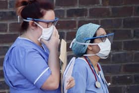 Hospital staff wear face masks outside Doncaster Royal Infirmary but who is responsible for the shortage of PPE equipment?