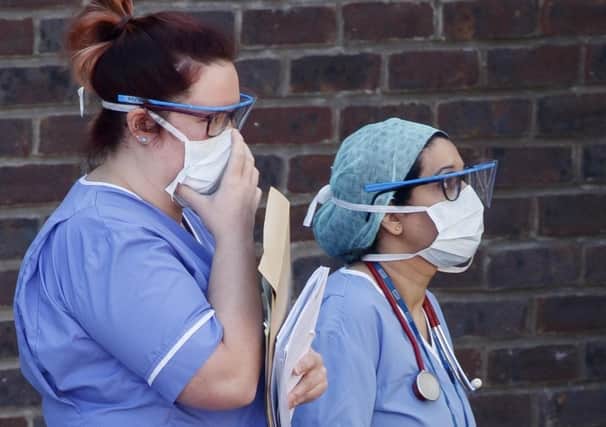 Hospital staff wear face masks outside Doncaster Royal Infirmary but who is responsible for the shortage of PPE equipment?