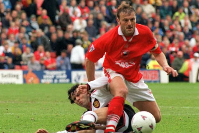 The two captains Neil Redfearn of Barnsley and Ryan Giggs  of Manchester United battle for the ball.