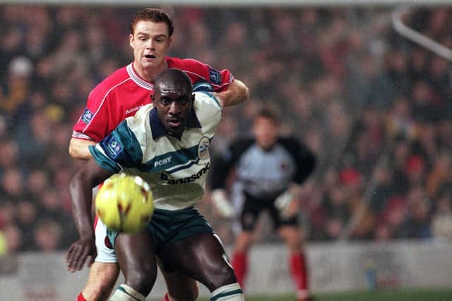 Barnsley's Adi Moses challenges Huddersfield's Wayne Allison.