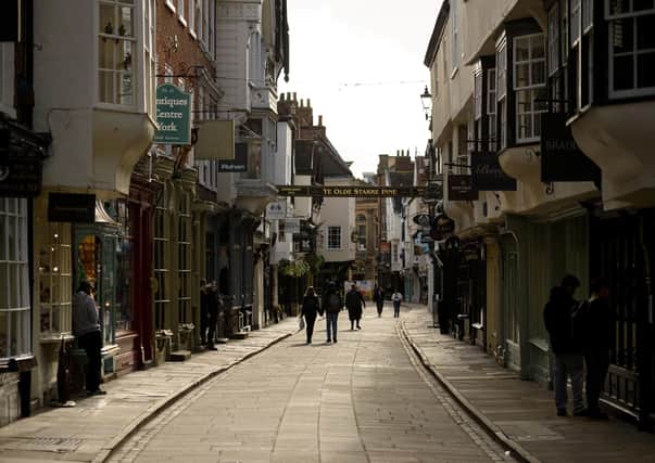 Pedestrians walk along an empty street in York as the lockdown takes its toll on tourism.