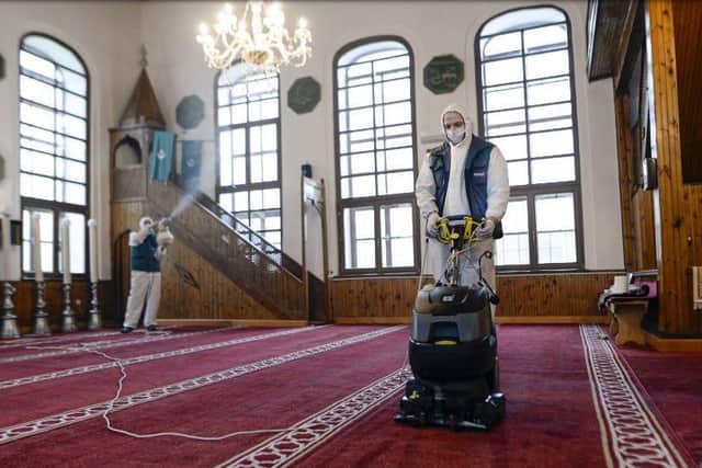 Workers disinfect the Cobanija mosque in Sarajevo, Bosnia. Disinfection began in mosques in the Bosnian capital Sarajevo and throughout the country, in order to limit the spread of the COVID-19 infections, ahead of holy month of Ramadan.(AP Photo/Kemal Softic)