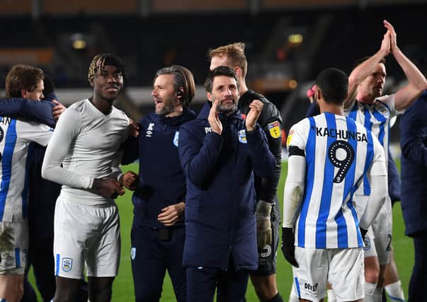 ON THE UP? Huddersfield Town's manager Danny Cowley and his brother Nicky join the players to celebrate the win at rivals Hull City. Picture: Jonathan Gawthorpe.