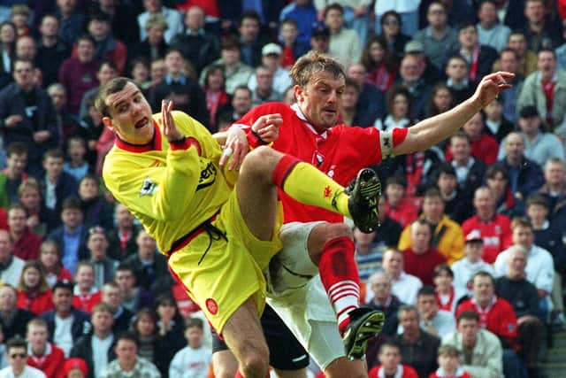 Premier action: Barnsley captain Neil Redfearn challenges  Steve Harkness, of Liverpool.