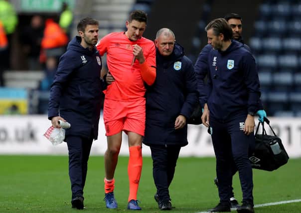 OUT: Huddersfield Town's Tommy Elphick leaves the pitch with an injury against Preston at Deepdale on November 9 which brought an end to his season. Picture: Richard Sellers/PA