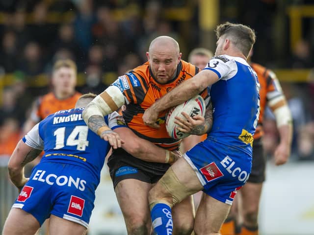 IN THE RUNNING: Castleford Tigers' Nathan Massey crashes into St Helens' Morgan Knowles and Lachlan Coote earlier this season.  Picture: Tony Johnson