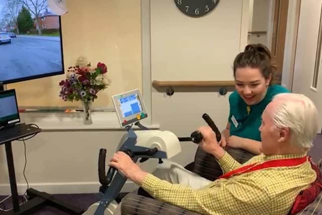 81 year old John Leng, a resident of Vida Healthcare since 21st May 2018, using the Motiview bike in Harrogate, North Yorkshire with Healthcare director Bernadette Mossman.