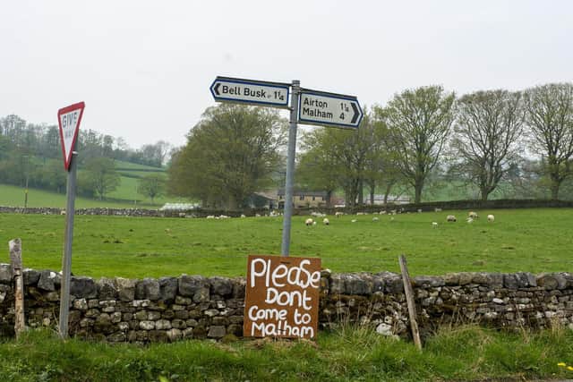 Local residents have erected hand-made signs begging visitors to stay away from Malham