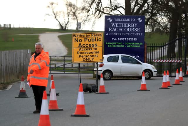 A car park attendant at Wetherby's meeting on March 18.