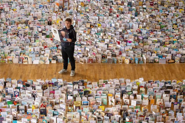 Captain Tom Moore's grandson Benjie, in the Great Hall of Bedford School, Bedfordshire, where over 120,000 birthday cards sent from around the world are being opened and displayed by staff. Captain Moore celebrates his 100th birthday today.