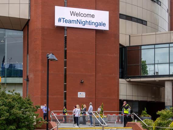 Staff holding a one-minute silence outside the Nightingale hospital at Harrogate Convention Centre to commemorate key workers on Kings Road Picture: James Hardisty