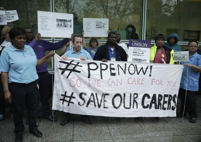 Hospital workers take part in a protest calling on the Government to provide PPE for all health workers.