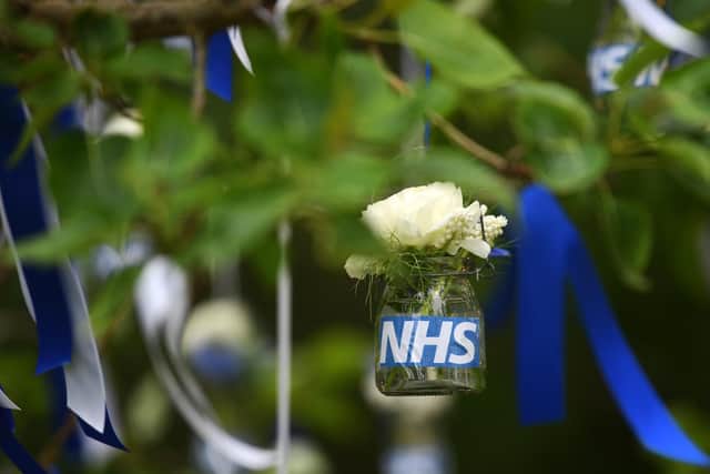 The stem happy tree has been adorned with more than 600 blue and white ribbons and 60 hanging flower vases to celebrate the NHS. Photo credit: Jonathan Gawthorpe/JPIMediaResell